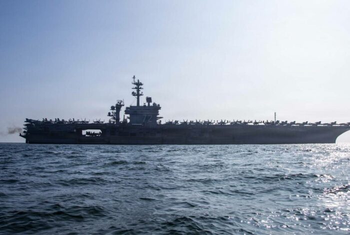 USS Abraham Lincoln aircraft carrier sailing in open water during deployment.