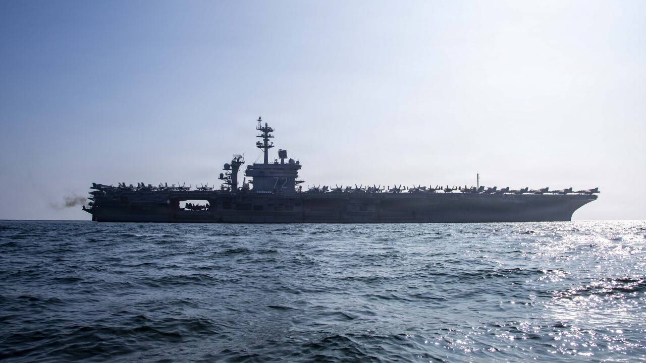 USS Abraham Lincoln aircraft carrier sailing in open water during deployment.
